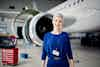 Women airplan hangar manager standing in front of plane