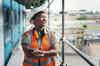 young Black woman construction worker smiling