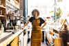 a woman standing in a coffee shop