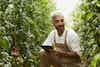 a man in overalls holding a tablet